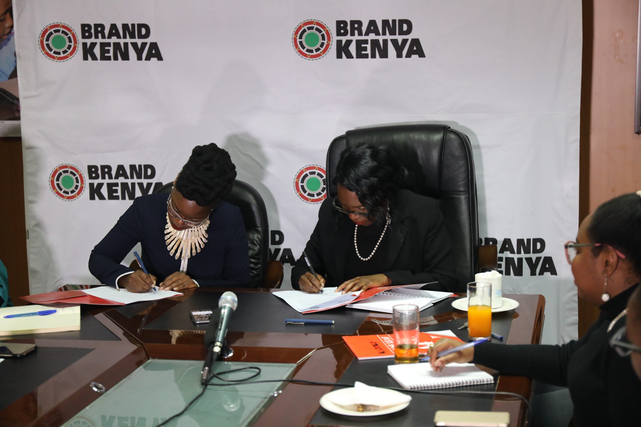 Ag. CEO Brand Kenya Board Ms Floice Mukabana (Right) signing a partnership deal to boost growth of the local fashion industry with Fashion Agenda Africa (FAA) Founder and fashion icon Akinyi E. Odongo (Left) at Brand Kenya Board offices this morning.
